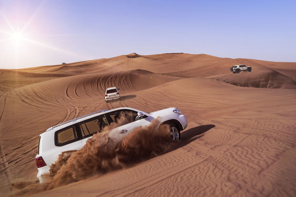 Desert Safari SUVs bashing through the arabian sand dunes