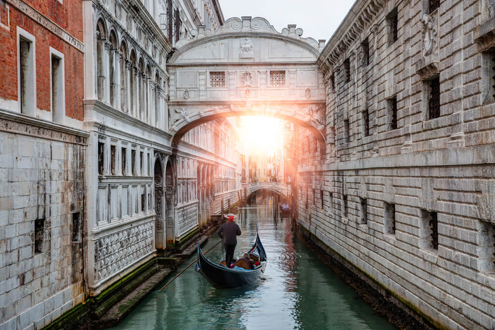 Gondolas floating on canal towards Bridge of Sighs (Ponte dei Sospiri). Venice, Italy