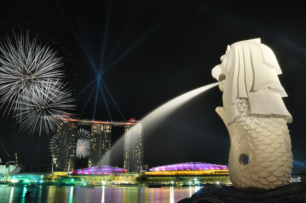 Singapore skyline and river shining with fireworks at night
